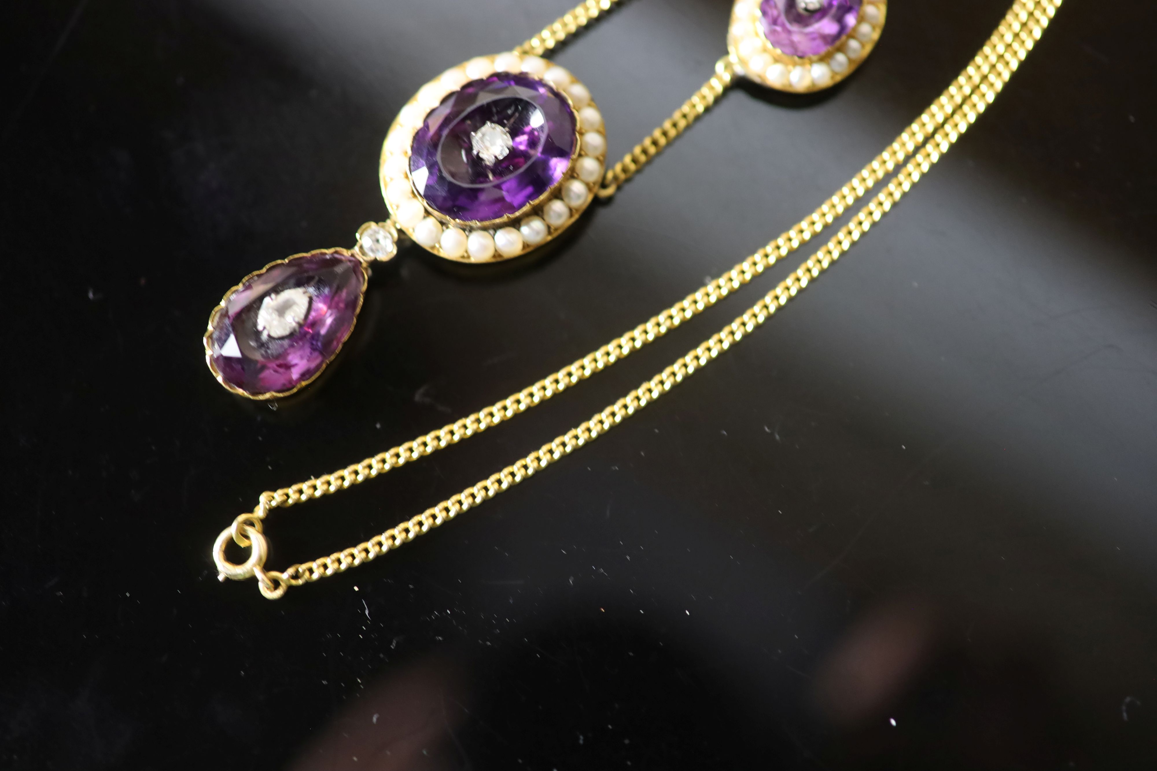 A Victorian style gold, amethyst, split pearl and old cut diamond cluster set drop necklace